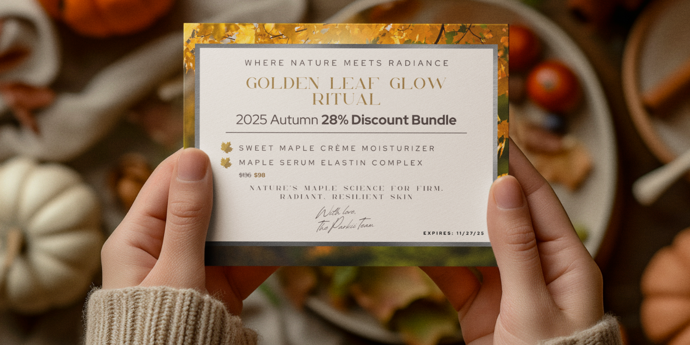 Hands holding a promotional card for Parkii Organic Skin Care's "Golden Leaf Glow Ritual" autumn discount bundle, featuring a gold-leaf border and  elegant typography.