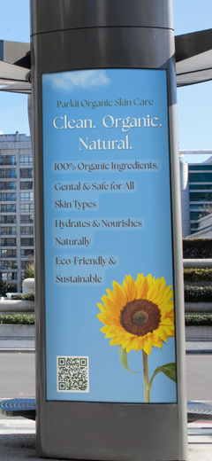 Tall outdoor pillar advertisement for Parkii Organic Skin Care featuring the tagline "Clean. Organic. Natural." with details about 100% organic, eco-friendly ingredients and a large sunflower image at the bottom.